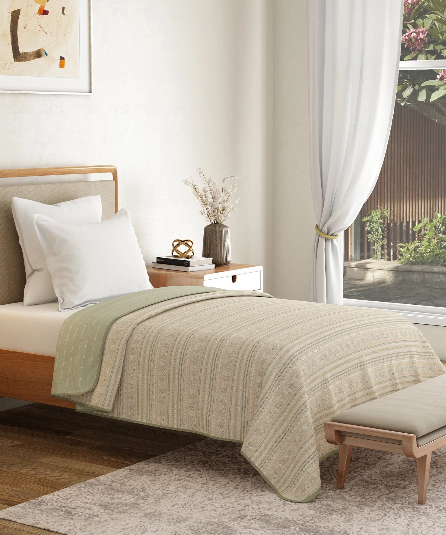 Traditional cream-and-green cotton dohar draped over a made bed, sheer curtain and wooden bench